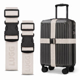 Stone luggage straps in two lengths beside hardshell suitcase, buckle detail