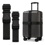 Black luggage straps in two lengths beside hardshell suitcase, buckle detail