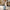 Sage Green luggage strap wrapped around light blue suitcase, woman travelling in city