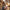 Woman in Paris with sage green travel neck pillow clipped to weekend duffel bag