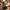 Woman in Paris with black travel neck pillow clipped to weekend duffel bag