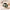 Sage green duffle bag flat lay with camera, jumper and bottle inside