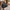 Man carrying black duffle bag by twin handles through a cobbled street