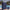 Midnight Blue weatherproof hard shell suitcase beside a pool on a sunny holiday