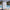 Slate Blue weatherproof hard shell suitcase beside a pool on a sunny holiday