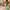 Woman rolling Mint cabin bag through courtyard, smooth-gliding 360 spinner wheels