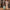 Woman rolling Sage Green cabin bag on cobblestones, smooth-gliding 360 spinner wheels