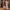 Woman rolling Rose Gold cabin bag on cobblestones, smooth-gliding 360 spinner wheels