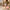 Woman rolling Clay cabin bag through courtyard, smooth-gliding 360 spinner wheels